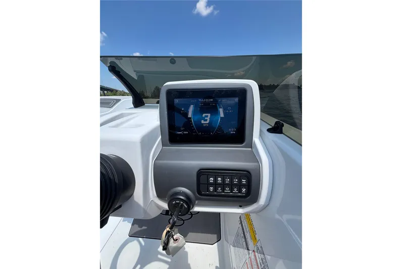 Slide: The Image of 2024 Tahoe T21 boat dashboard with digital display and control panel. - 13