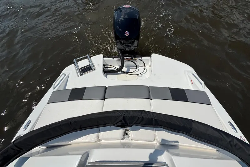 Slide: The Image of 2024 Tahoe T21 boat rear view with motor and swim platform on water. - 10
