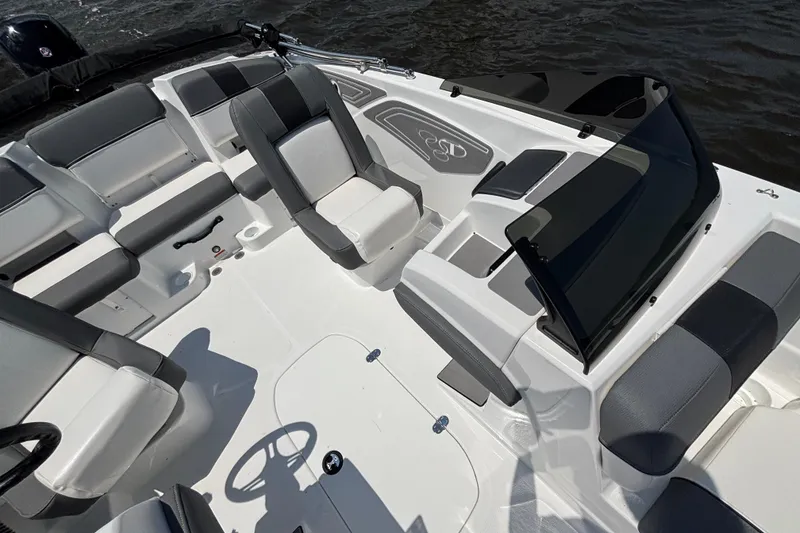 Slide: The Image of 2024 Tahoe T21 boat interior with sleek seating and modern design on the water. - 8