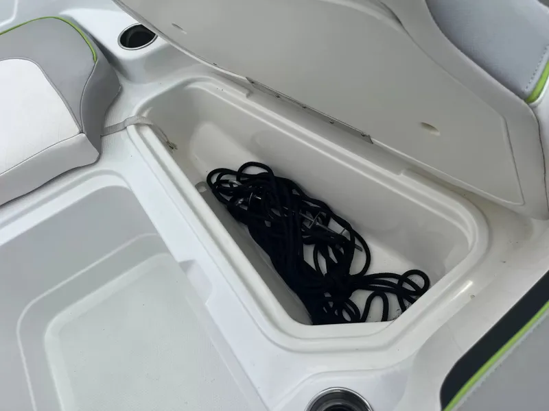 Slide: The Image of An open storage compartment in a boat with a black rope inside. - 17
