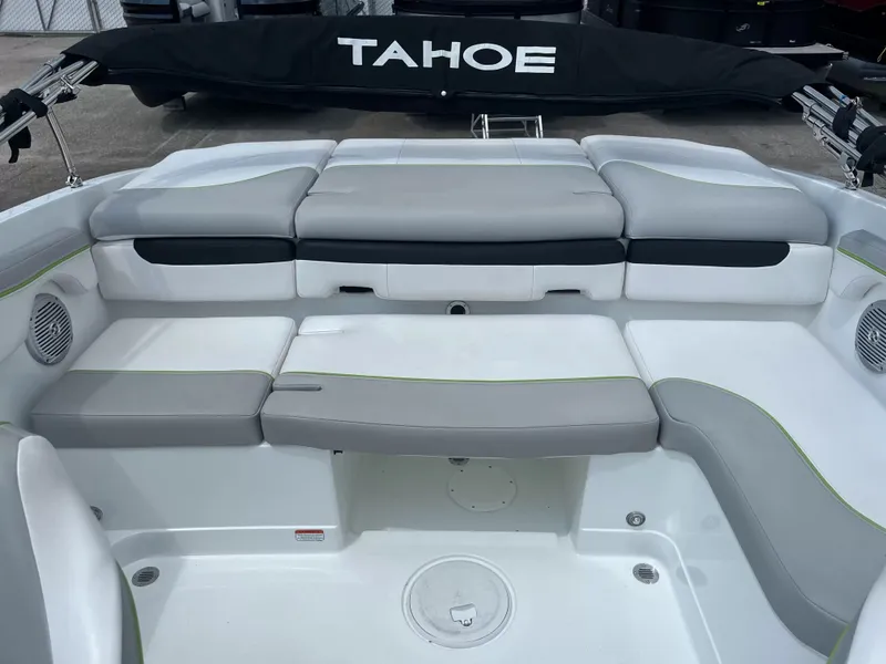 Slide: The Image of The image shows the cockpit of a 2018 Tracker TAHOE 700 MOK with gray and white seating. - 5