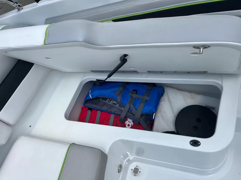 Slide: The Image of An open storage compartment on a boat reveals life jackets and other gear. - 7