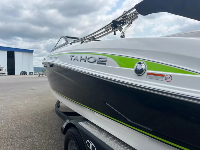 Slide: The Image of A 2018 Tracker TAHOE 700 MOK boat on a trailer, featuring a sleek white and green design. - 12