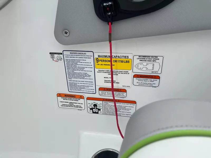 Slide: The Image of Close-up of safety warnings and capacity information on a boat. - 15