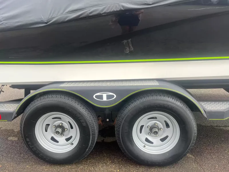 Slide: The Image of Close-up of a boat trailer with two wheels and a black boat cover. - 3