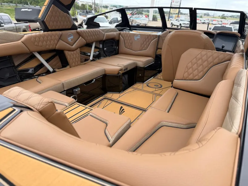 Slide: The Image of Luxurious interior of a 2027 Tigé 24RZX with brown leather seating and modern detailing. - 11