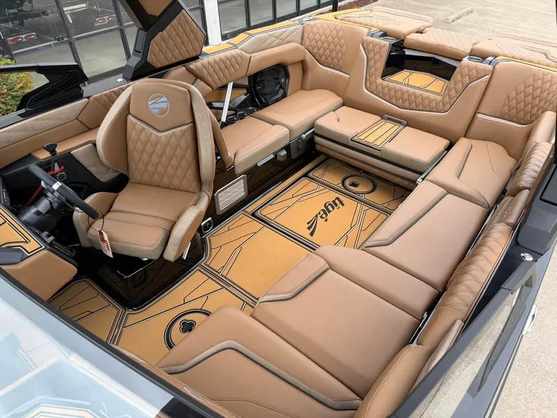 Slide: The Image of The image shows the luxurious interior of a Tigé 24RZX boat with brown leather seating and stylish flooring. - 22