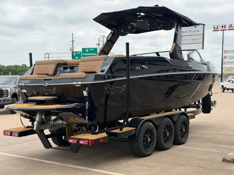 Slide: The Image of 2027 Tigé 24RZX: Luxurious black motorboat on a trailer, ready for adventure. - 5
