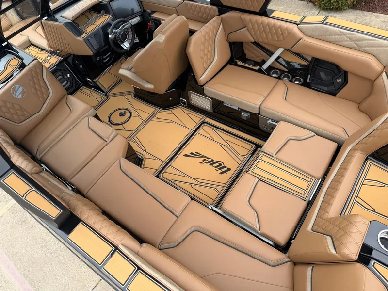 Slide: The Image of Luxurious interior of a 2027 Tigé 24RZX with brown upholstery and modern detailing. - 12