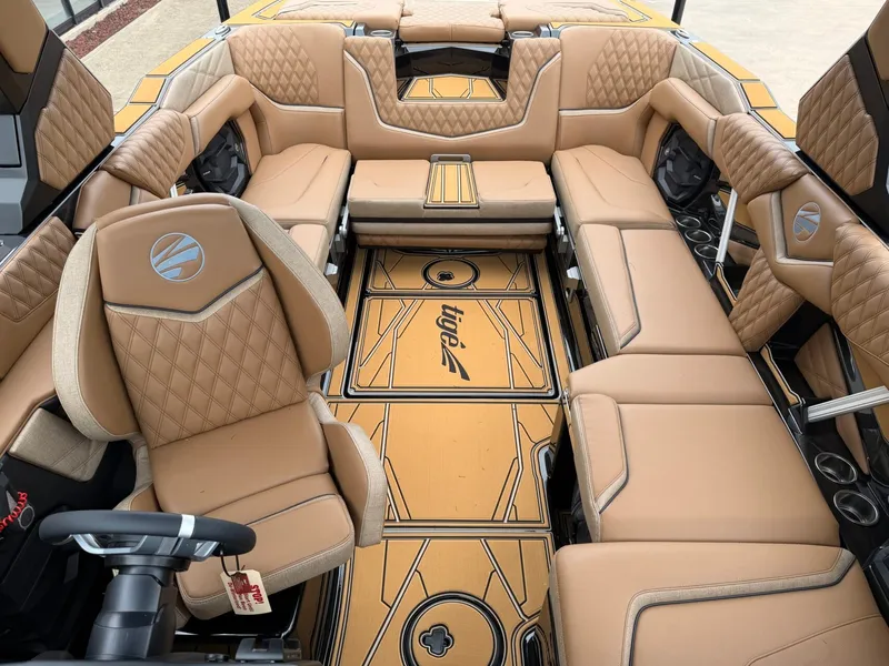 Slide: The Image of The image shows the luxurious interior of a Tigé 24RZX boat with beige upholstery. - 21