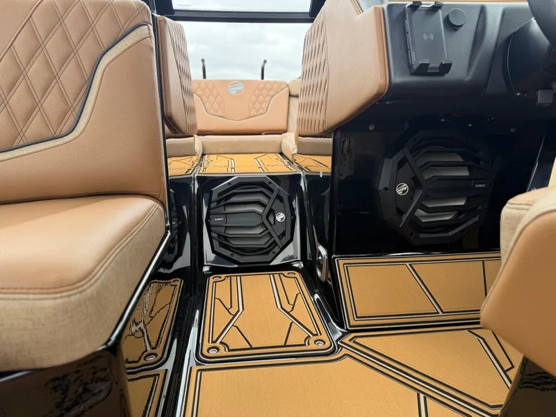 Slide: The Image of Interior of a 2027 Tigé 24RZX with luxurious brown leather seats and stylish flooring. - 19