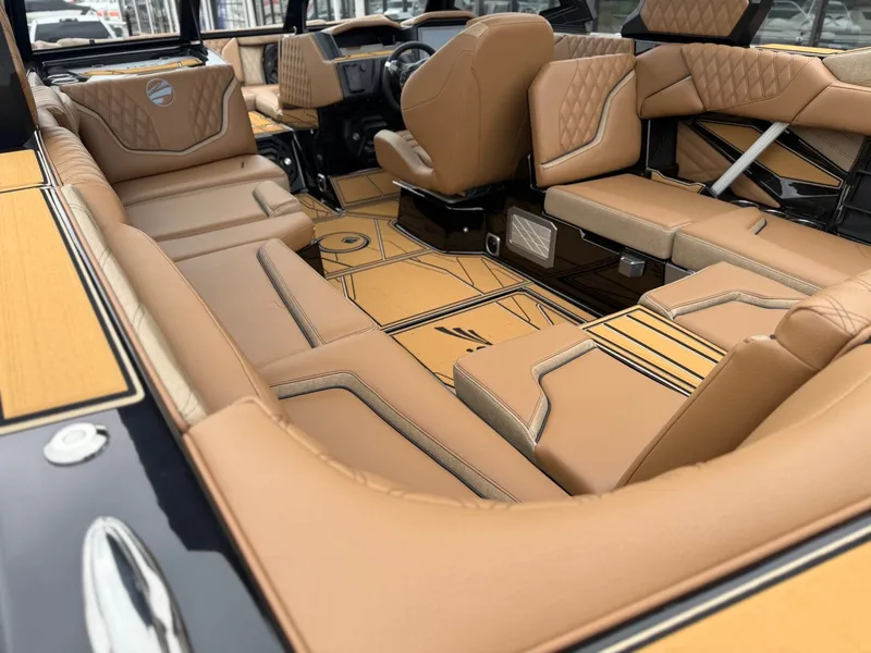 Slide: The Image of The image shows the luxurious interior of a Tigé 24RZX boat with elegant brown upholstery. - 13