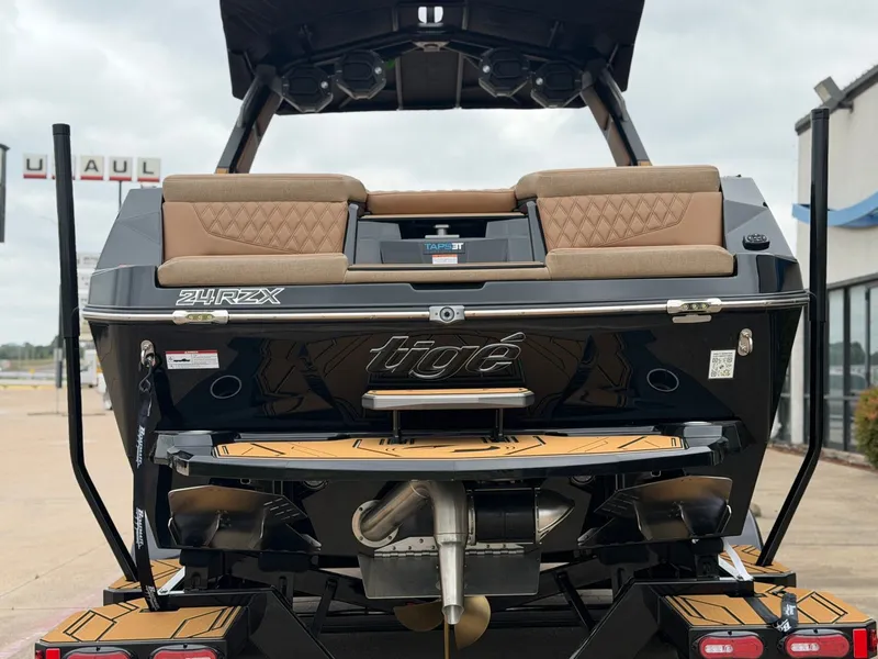 Slide: The Image of The image shows the rear of a 2027 Tigé 24RZX boat with brown seating and a modern design. - 4