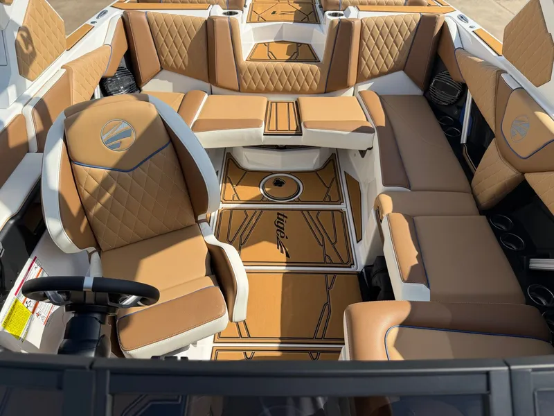 Slide: The Image of The image shows the luxurious interior of a Tigé Z1 boat with elegant brown leather seating. - 18