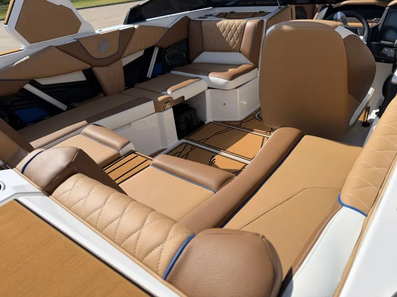 Slide: The Image of The image shows the luxurious interior of a Tigé Z1 boat with elegant brown leather seating. - 10