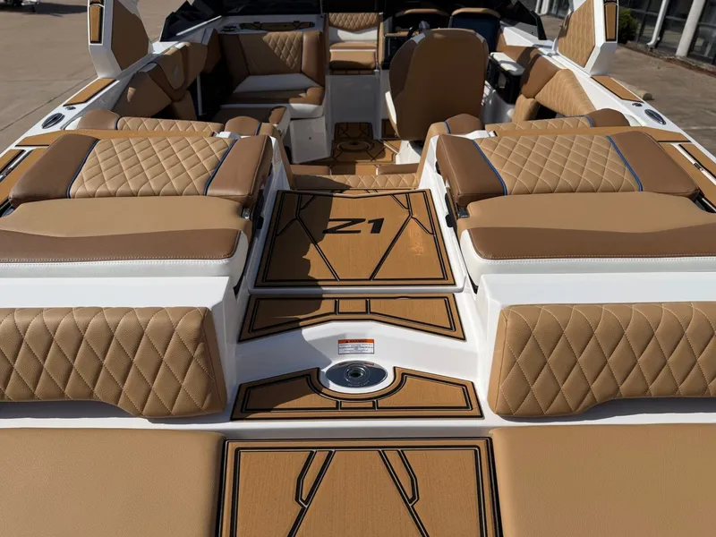 Slide: The Image of The image shows the interior of a 2027 Tigé Z1 boat with brown upholstery and sleek details. - 7