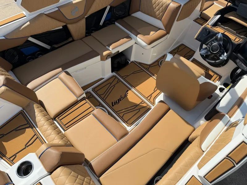 Slide: The Image of The image shows the luxurious interior of a Tigé Z1 boat with brown upholstery and modern details. - 9