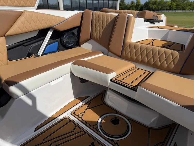 Slide: The Image of The image shows the luxurious interior of a Tigé Z1 boat with brown and white upholstery. - 14