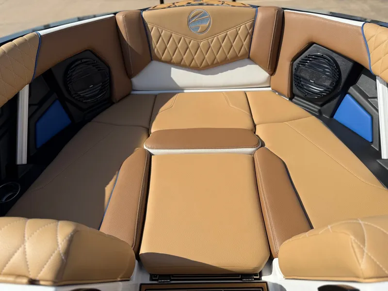 Slide: The Image of The image shows the interior of a 2027 Tigé Z1 boat with brown upholstery and speakers. - 17