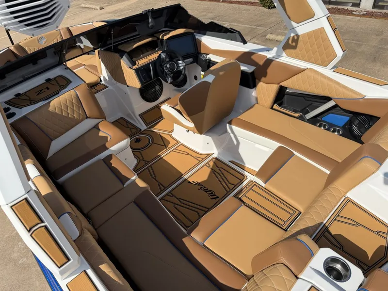 Slide: The Image of The image shows the interior of a 2027 Tigé Z1 boat with brown and white upholstery. - 11