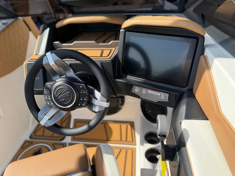Slide: The Image of The image shows the cockpit of a 2027 Tigé Z1 boat with a modern steering wheel and large screen. - 16