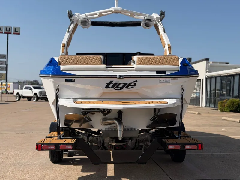 Slide: The Image of The image shows a 2027 Tigé Z1 boat on a trailer, ready for transport. - 4