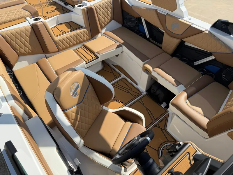 Slide: The Image of The image shows the luxurious interior of a 2027 Tigé Z1 boat with brown leather seating. - 20