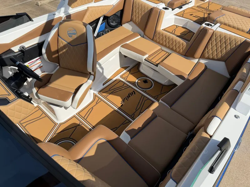 Slide: The Image of The image shows the luxurious interior of a 2027 Tigé Z1 boat with elegant brown upholstery. - 19
