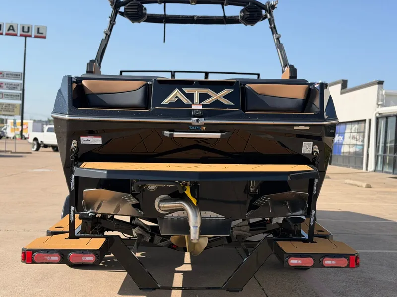 Slide: The Image of The image shows the rear of a 2027 ATX Surf Boats 22 Type-S. It features a modern design with a large ATX logo and a platform at the back. - 4