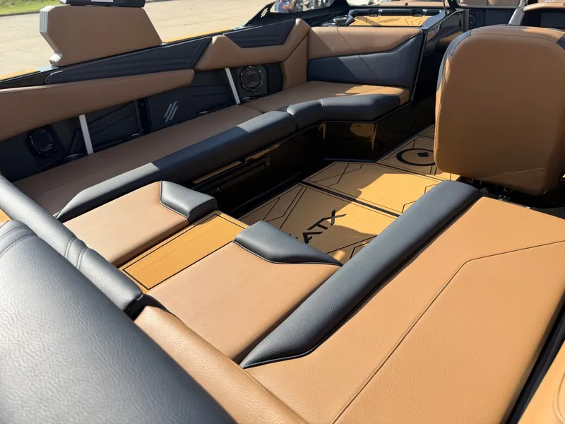 Slide: The Image of The image shows the luxurious interior of an ATX Surf Boats 22 Type-S with brown and black seating. - 10