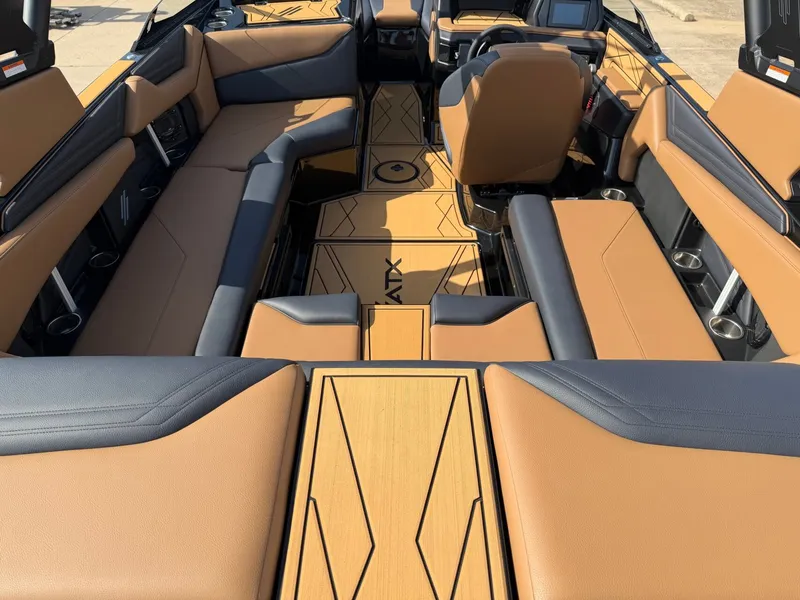 Slide: The Image of The image shows the interior of a 2027 ATX Surf Boats 22 Type-S with brown and black seating. - 7