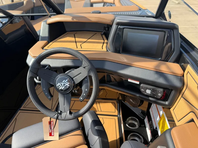 Slide: The Image of The image shows the cockpit of a 2027 ATX Surf Boats 22 Type-S with a modern steering wheel and display. - 16
