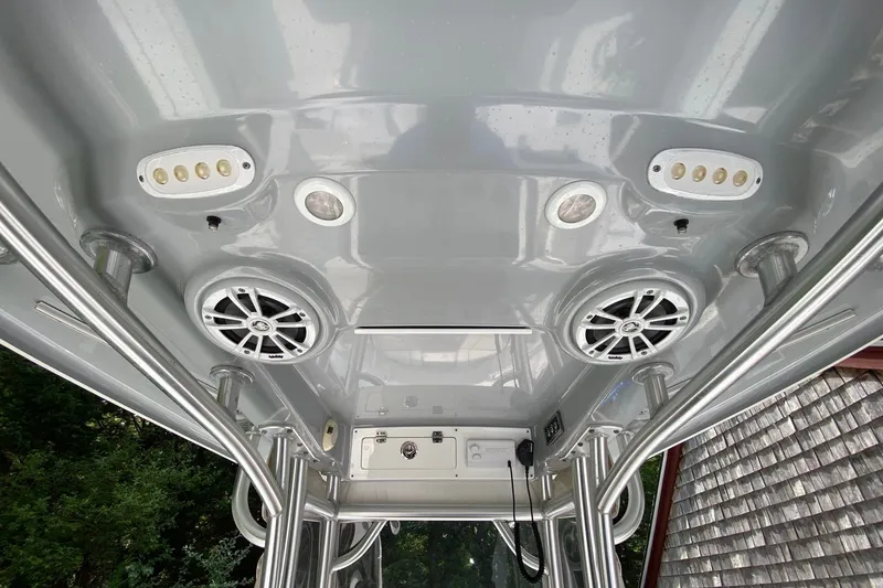 Slide: The Image of 2018 Sportsman Open 242 Center Console boat roof with speakers and lights. - 13
