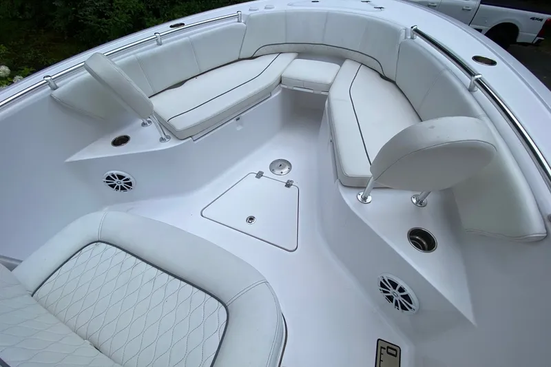 Slide: The Image of 2018 Sportsman Open 242 Center Console boat with white cushioned seating and stainless steel fixtures. - 11