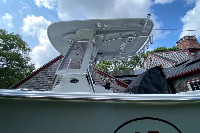 Slide: The Image of 2018 Sportsman Open 242 Center Console boat with T-top, against a blue sky background. - 3