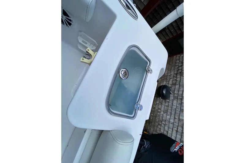 Slide: The Image of 2018 Sportsman Open 242 Center Console boat interior with storage compartment. - 22