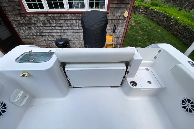 Slide: The Image of 2018 Sportsman Open 242 Center Console boat interior with seating and storage. - 25