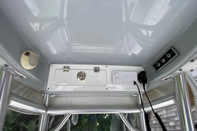 Slide: The Image of 2018 Sportsman Open 242 Center Console boat interior with control panel and speaker. - 14