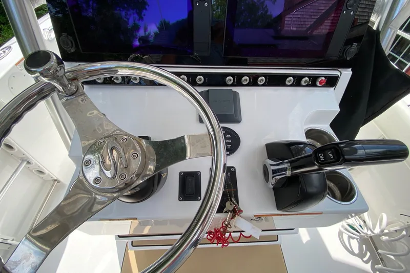 Slide: The Image of 2018 Sportsman Open 242 Center Console dashboard with steering wheel and controls. - 6