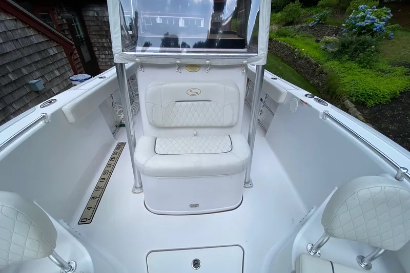 Slide: The Image of 2018 Sportsman Open 242 Center Console boat interior with white seating and measuring ruler. - 29