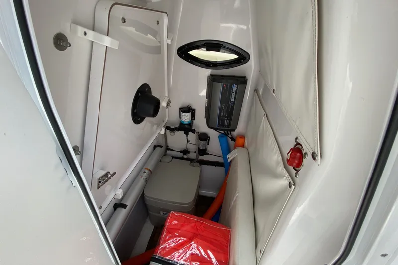 Slide: The Image of Interior of 2018 Sportsman Open 242 Center Console boat, featuring storage and equipment. - 23