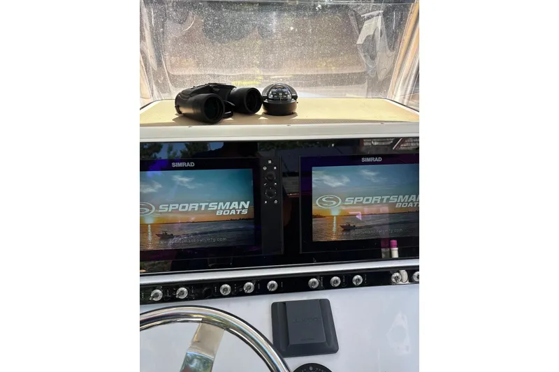 Slide: The Image of 2018 Sportsman Open 242 Center Console dashboard with dual Simrad displays and binoculars. - 8