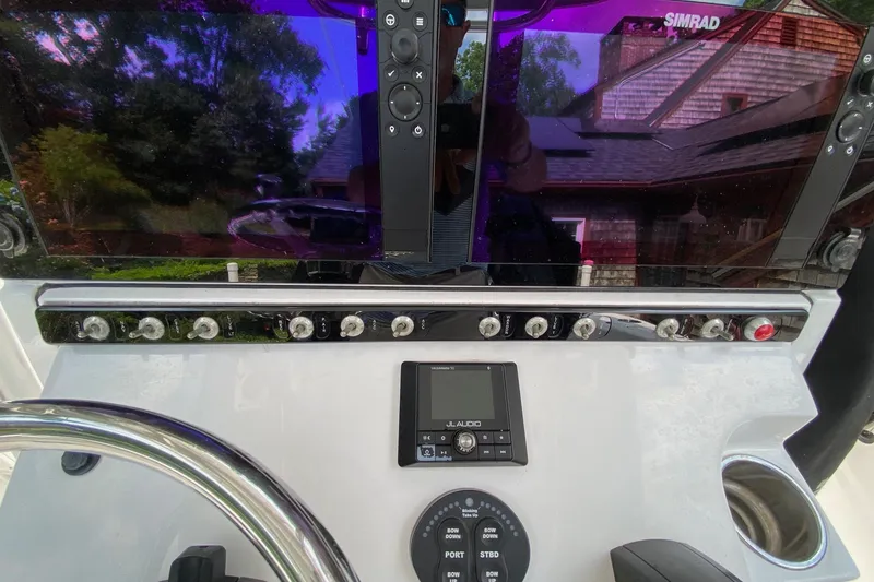 Slide: The Image of Control panel of a 2018 Sportsman Open 242 Center Console boat with Simrad display. - 7