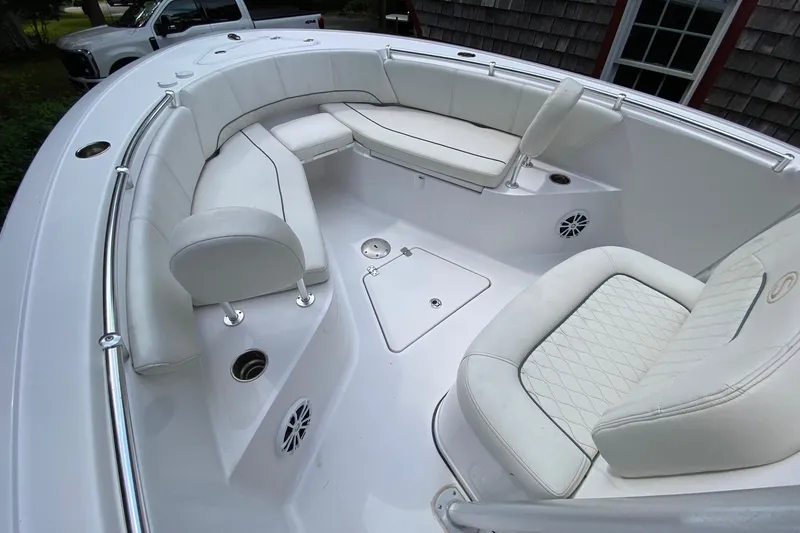 Slide: The Image of 2018 Sportsman Open 242 Center Console boat with white cushioned seating. - 12
