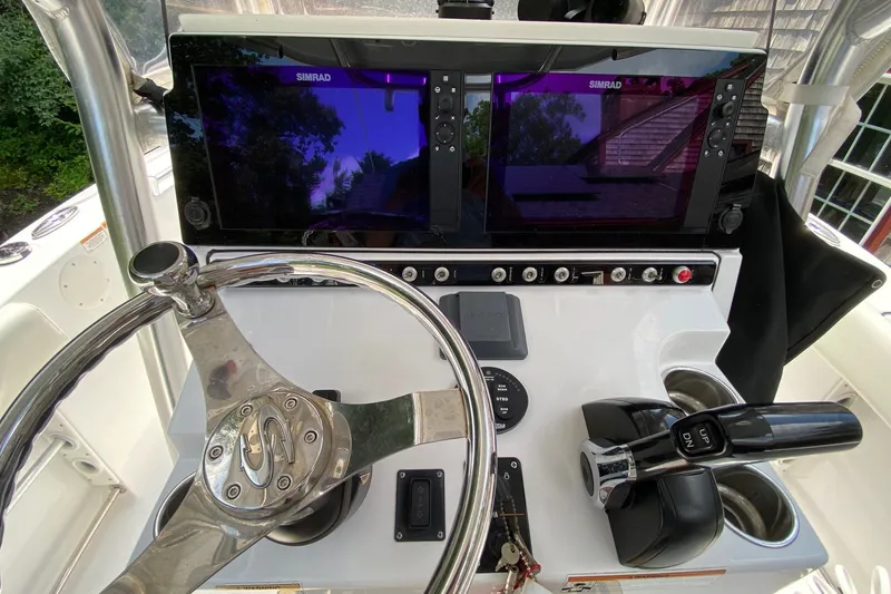 Slide: The Image of 2018 Sportsman Open 242 Center Console helm with dual Simrad displays and steering wheel. - 5