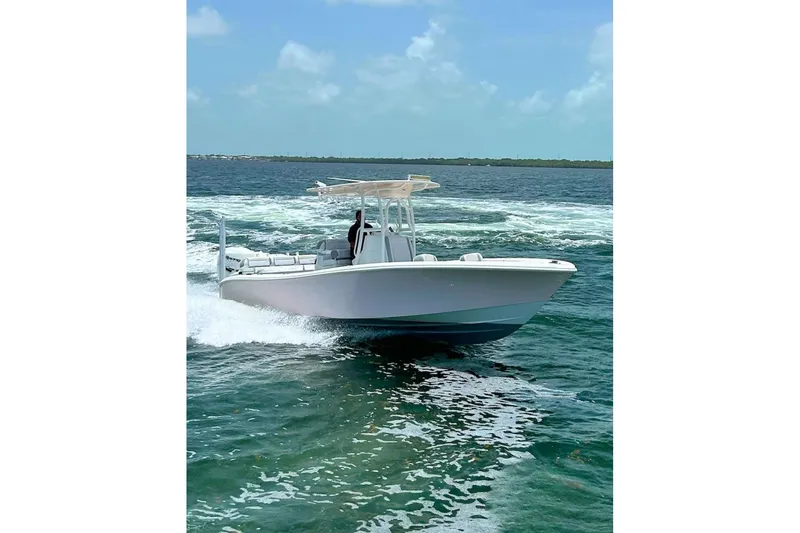 Slide: The Image of 2018 Yellowfin 26 Hybrid boat cruising on open water under clear skies. - 3