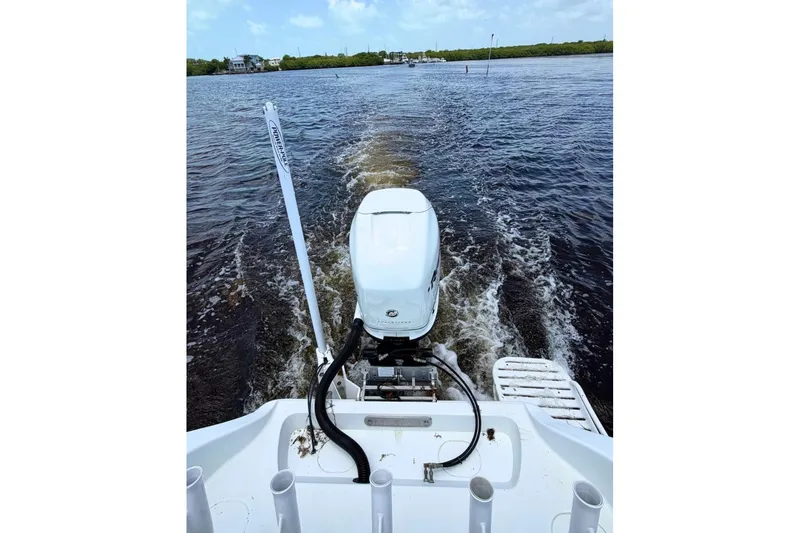 Slide: The Image of 2018 Yellowfin 26 Hybrid boat cruising on open water, showcasing powerful outboard motor. - 18