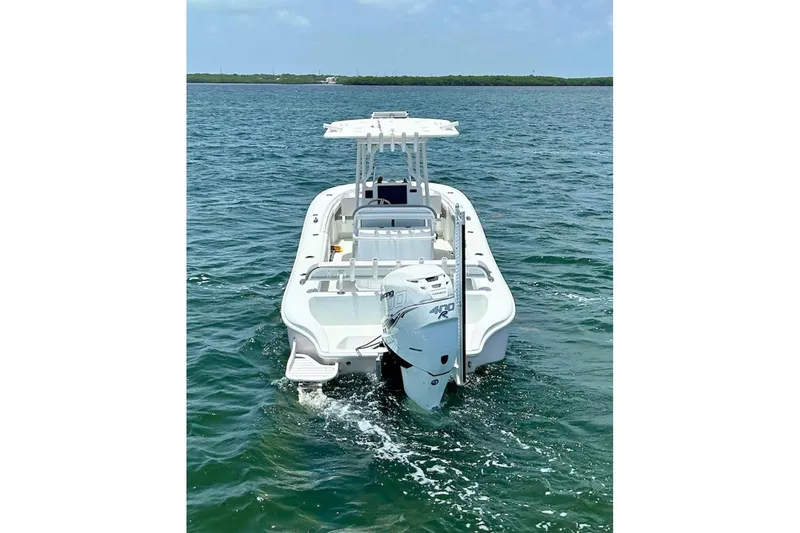 Slide: The Image of 2018 Yellowfin 26 Hybrid boat on open water, rear view with outboard motor. - 9
