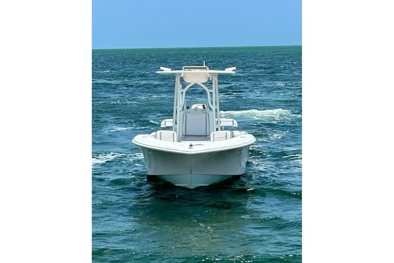 Slide: The Image of 2018 Yellowfin 26 Hybrid boat navigating on open water. - 7