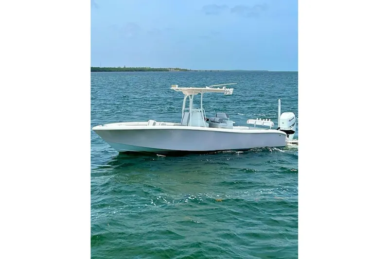 Slide: The Image of 2018 Yellowfin 26 Hybrid boat on open water, showcasing sleek design and performance. - 4